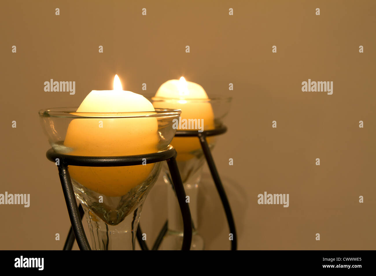 Candles slowly burning in a lounge interior Stock Photo Alamy