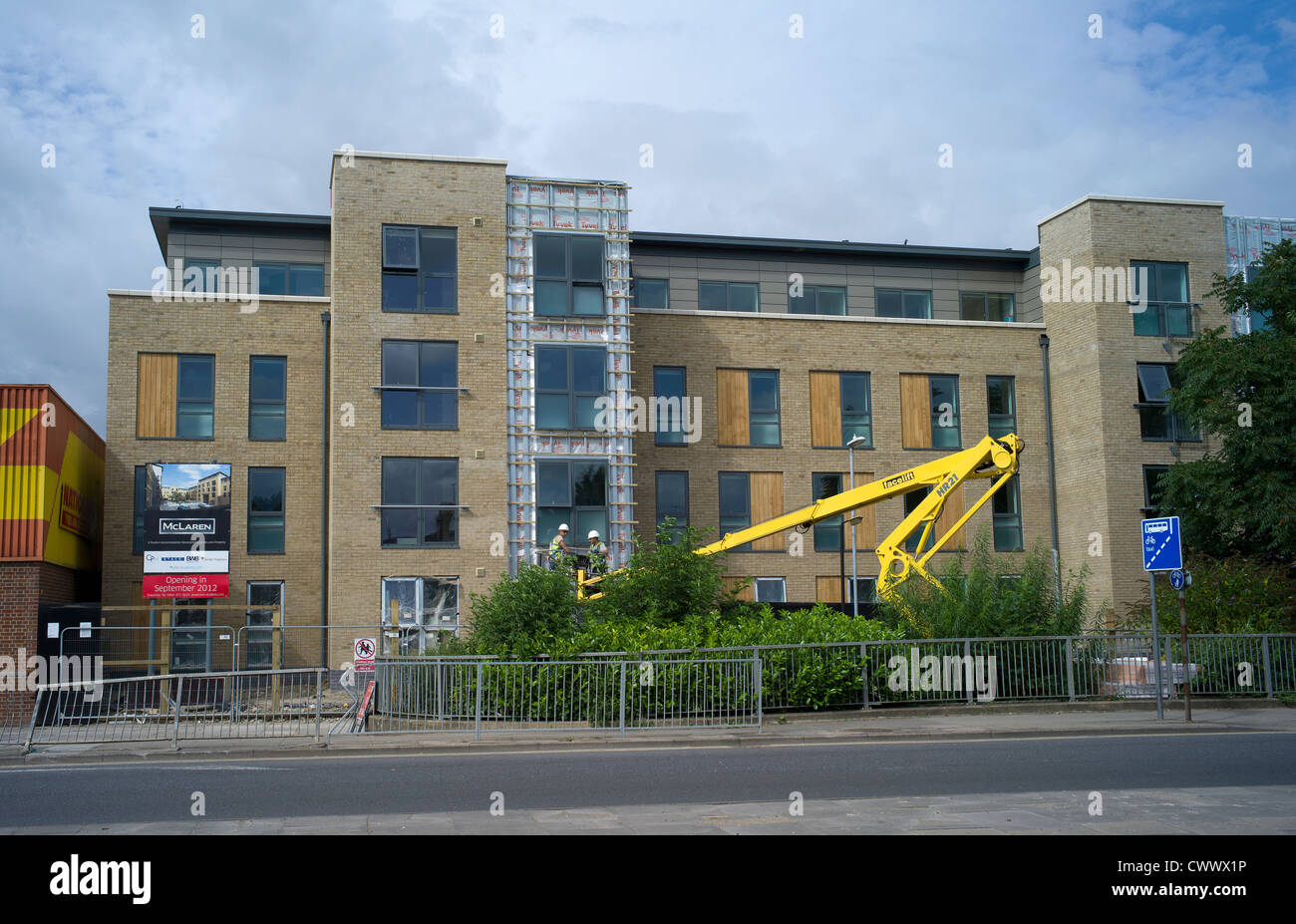 Face lift machine in operation on front of new building Cambridge Stock Photo