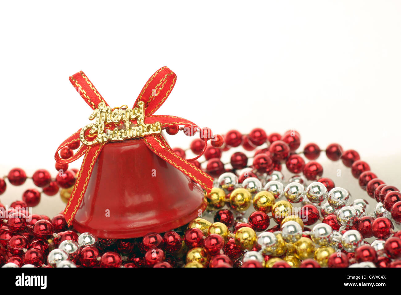 red Merry Christmas bell on beads Stock Photo