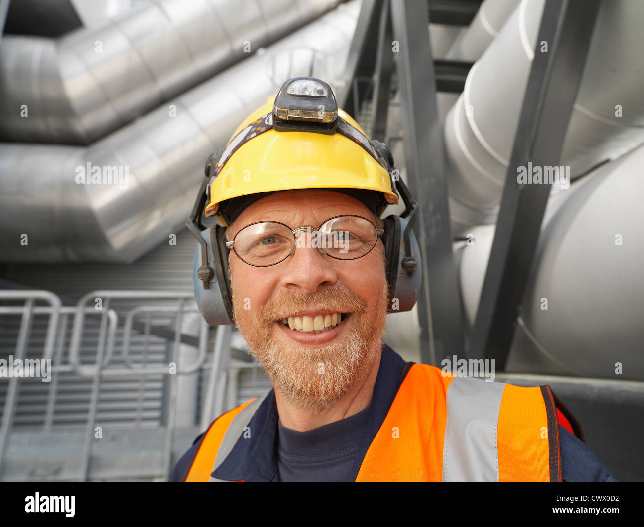 Worker wearing hard hat in factory Stock Photo