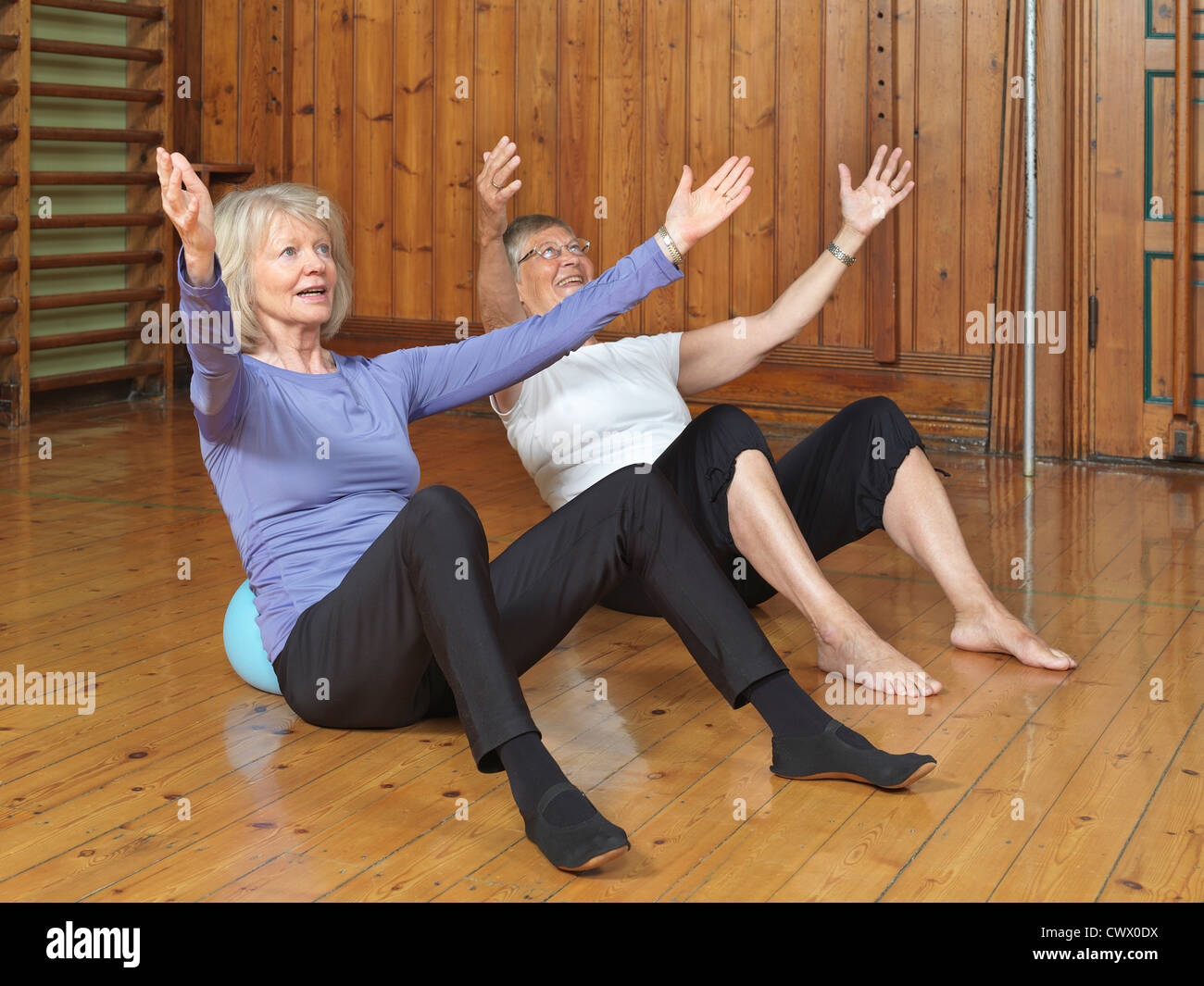 Women practicing yoga together in studio Stock Photo