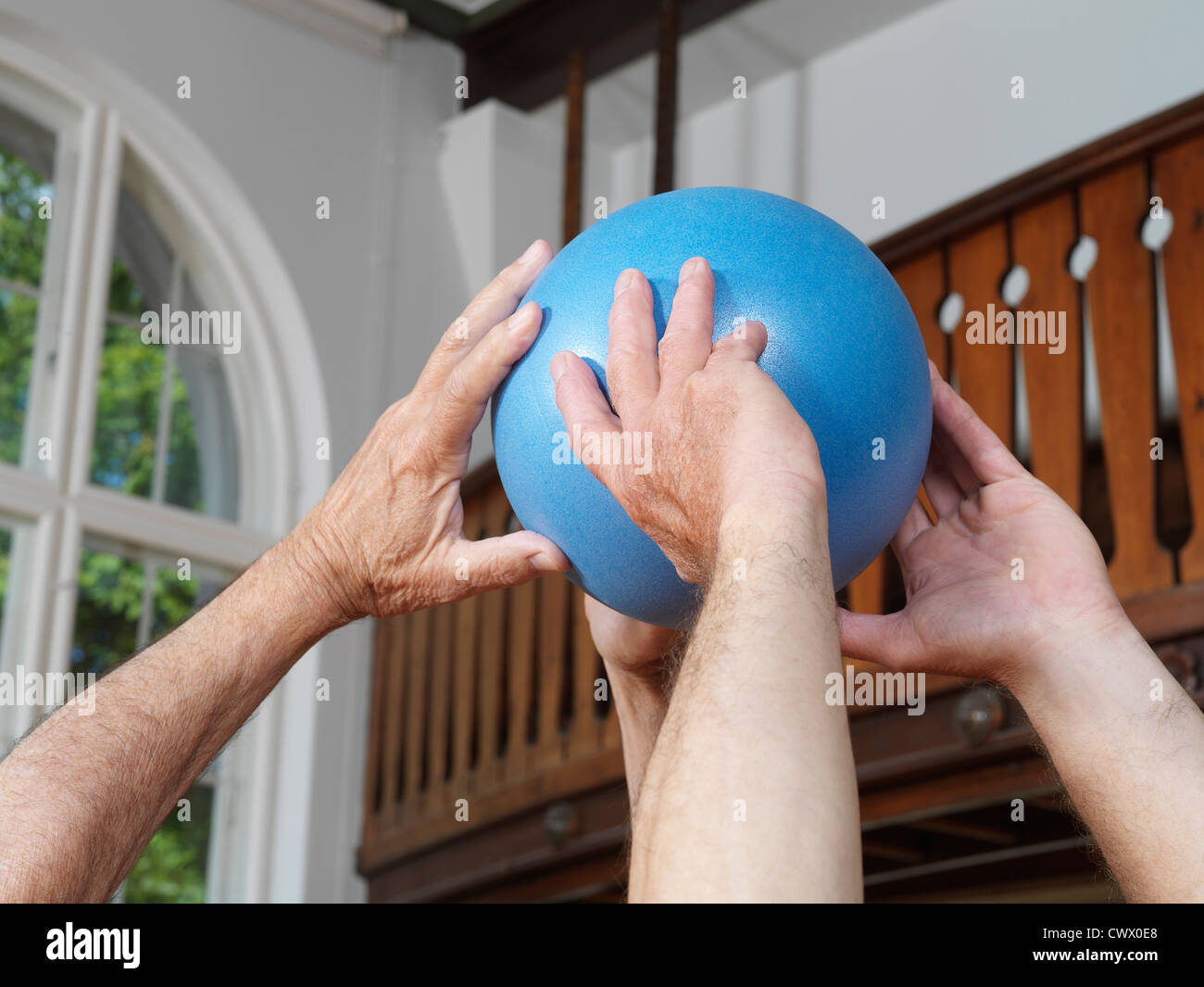 Close up of men passing rubber ball Stock Photo