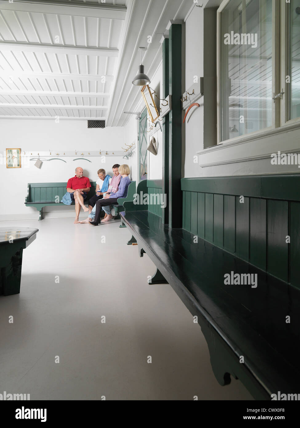Older people sitting in locker room Stock Photo