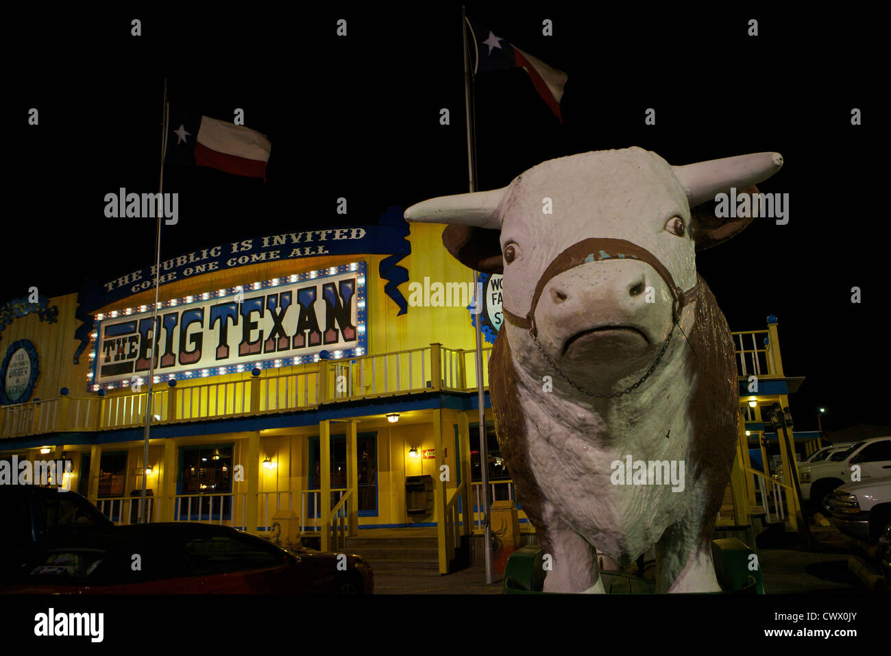 Cow statue in front of the Big Texan restaurant along Route 66 at night