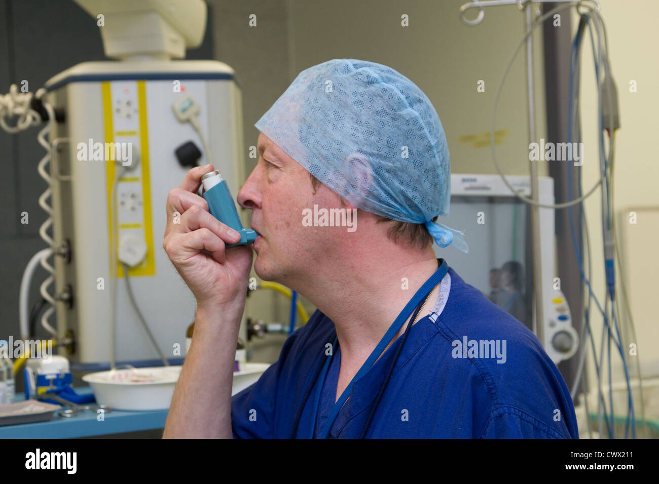 Theatre technician using an inhaler Stock Photo Alamy