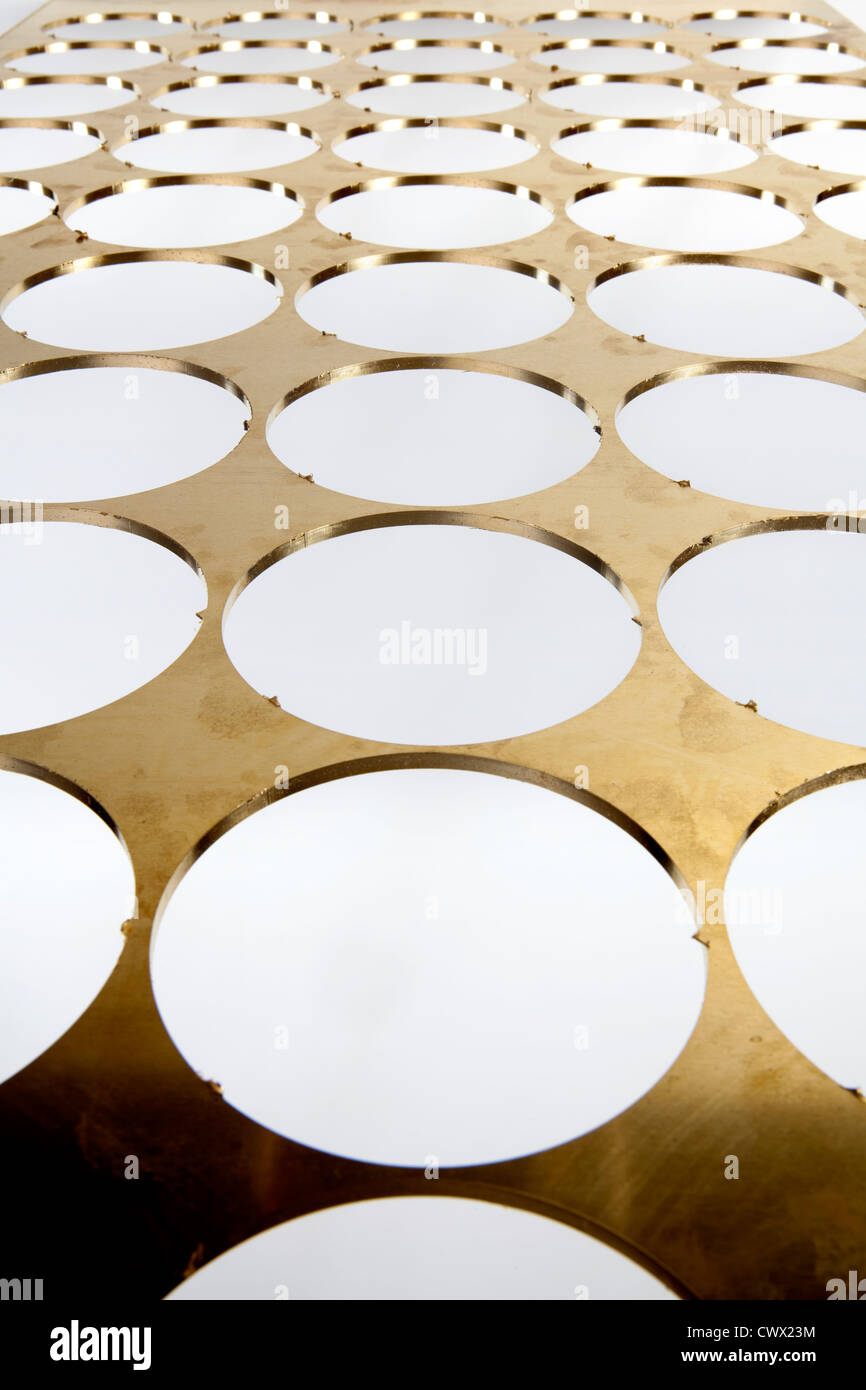 Brass sheet with round holes, brass scrap Stock Photo Alamy