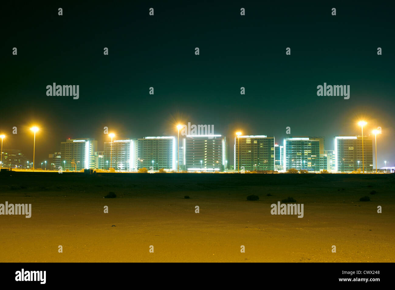Urban skyline lit up at night Stock Photo