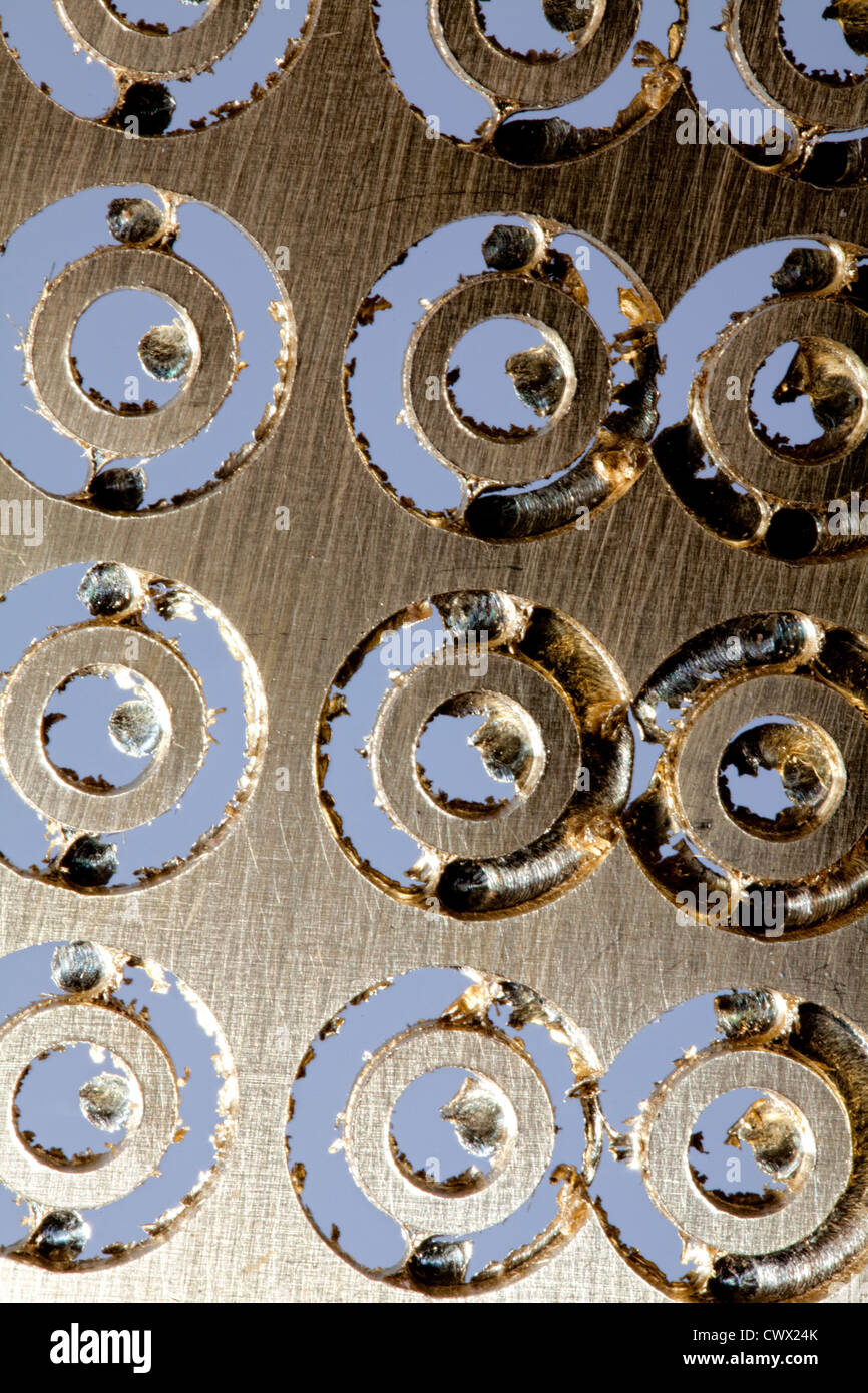 Brass sheet with round holes, brass scrap Stock Photo Alamy