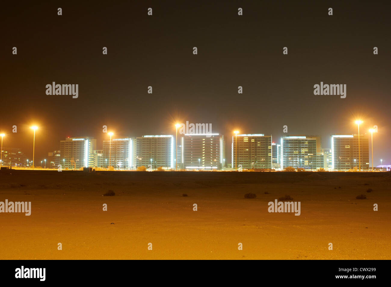 Urban skyline lit up at night Stock Photo