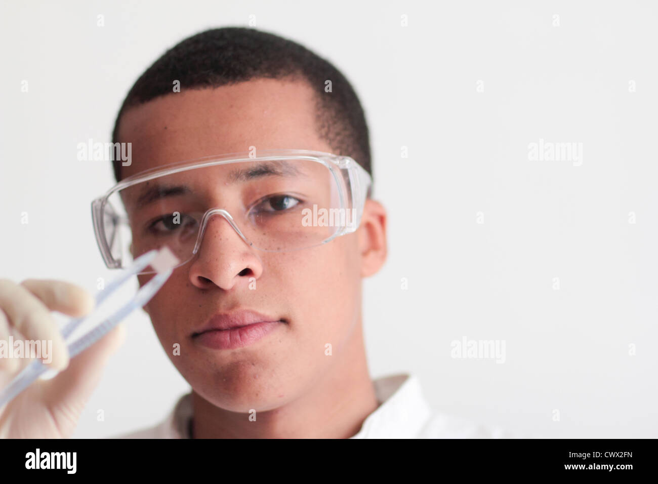 Student holding microchip in science lab Stock Photo Alamy