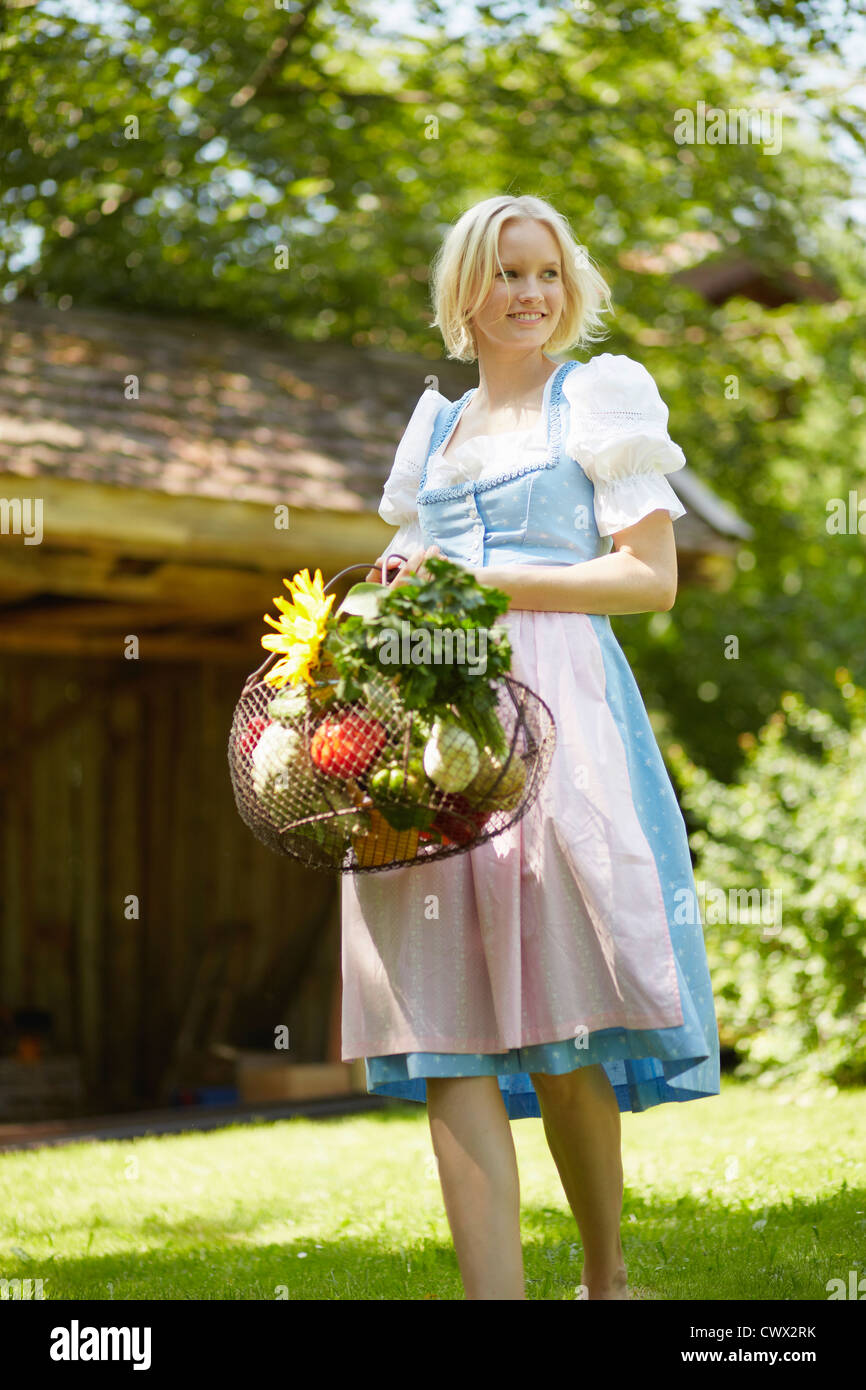 Woman with basket of fresh vegetables Stock Photo - Alamy