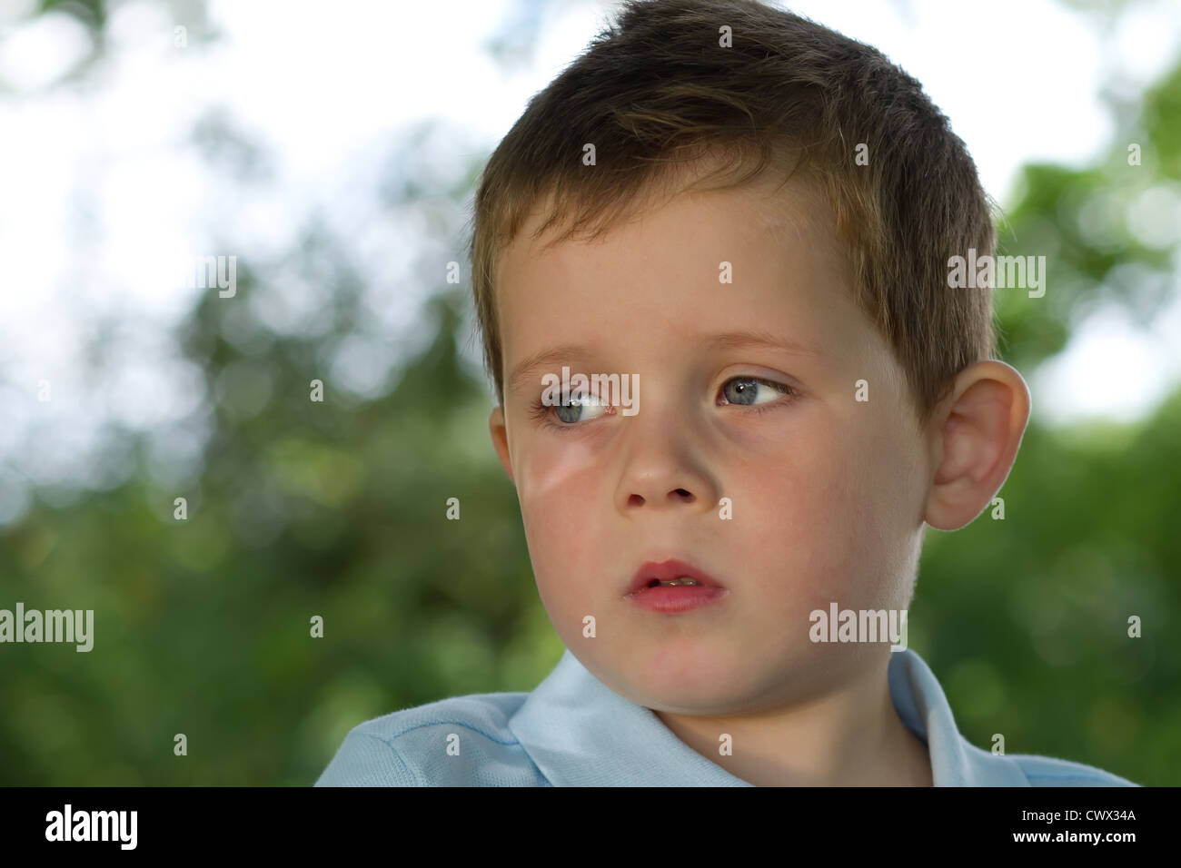 little boy looking to his right in countryside Stock Photo