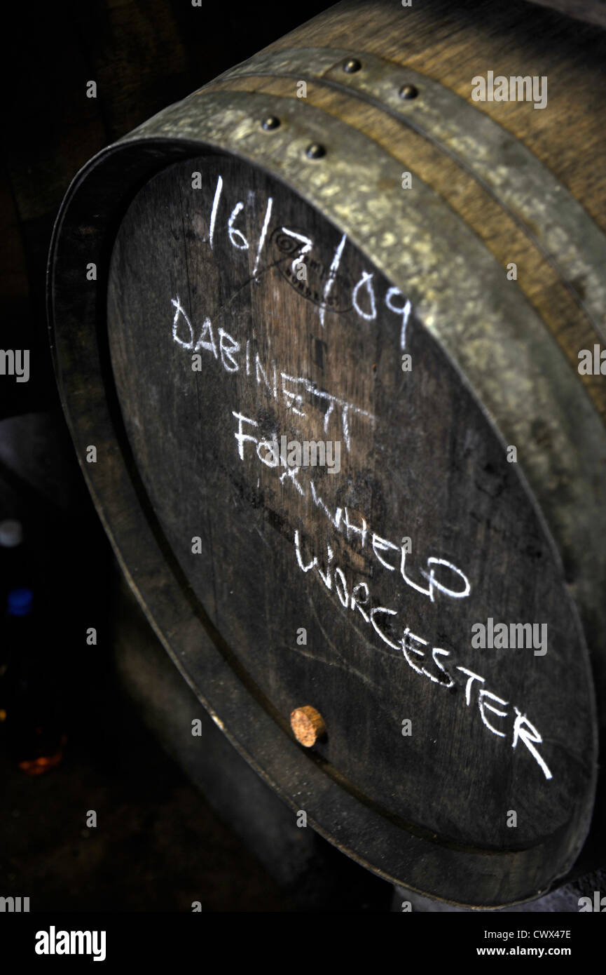 A barrel of cider with the varieties of apples used chalked on the front in a farmshop on an English farm, Herefordshire, UK Stock Photo