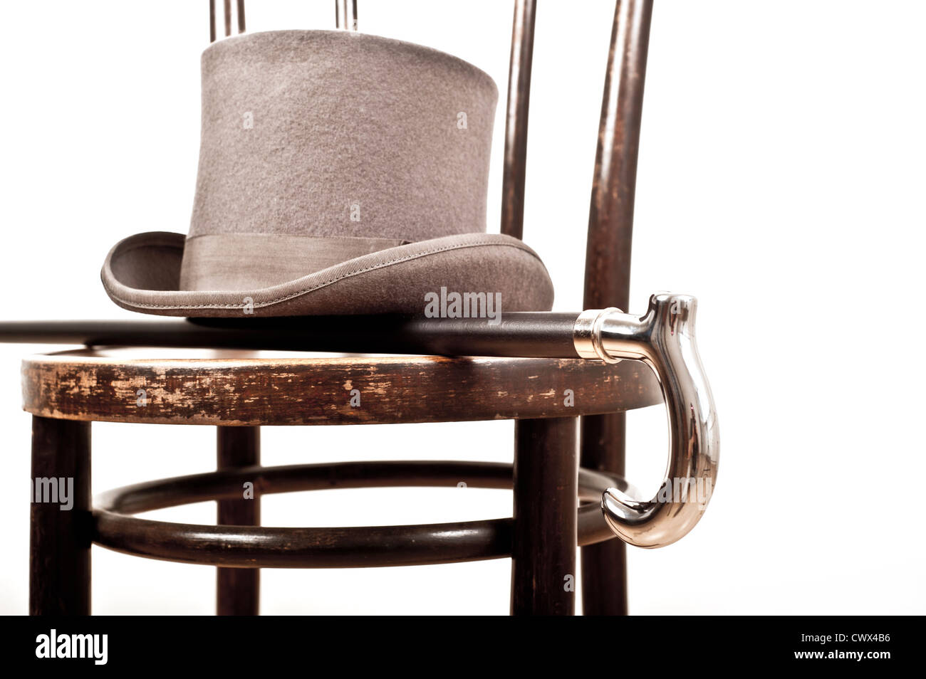 top hat and walking stick on a chair Stock Photo