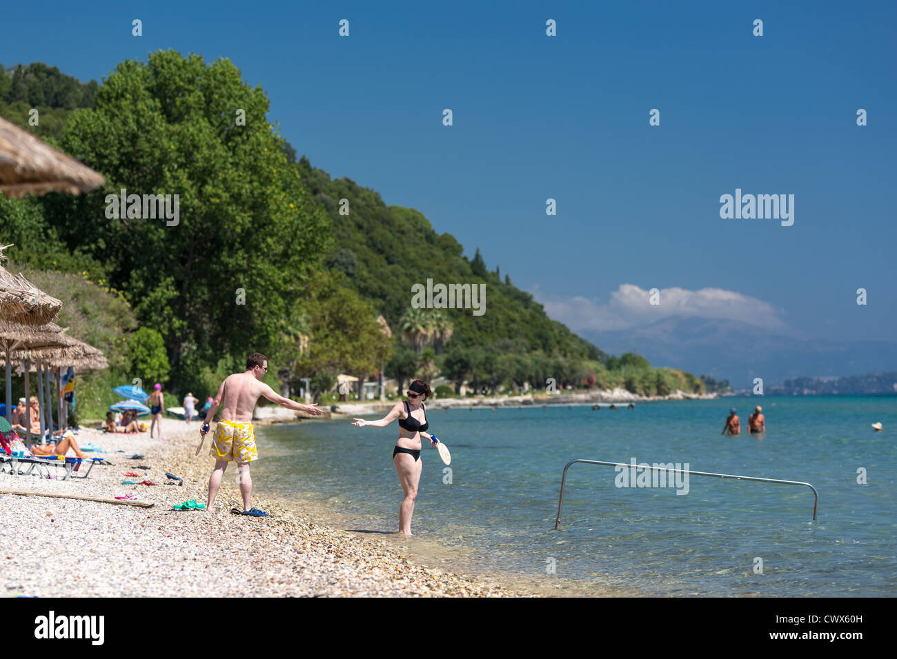 Tourists on a beach in Moraitika, Corfu, Ionian Islands, Greece. Stock Photo