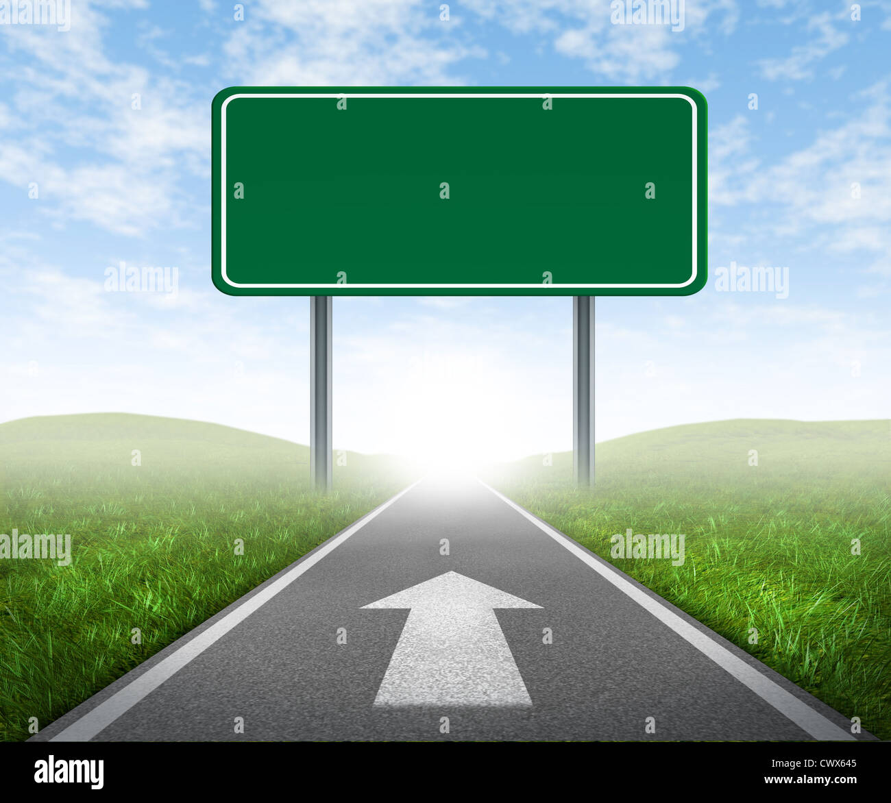 Clear goals on an open straight road highway sign with green grass and asphalt street representing the concept of journey to a focused destination resulting in success and happiness with an arrow on the pavement. Stock Photo