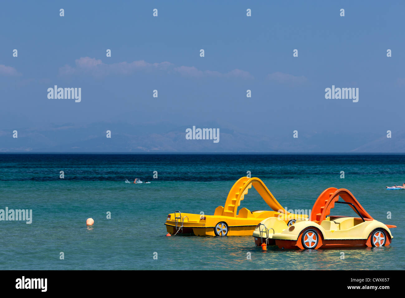 Empty yellow plastic paddle boats for rent in Moraitika, Corfu, Ionian Islands, Greece. Stock Photo