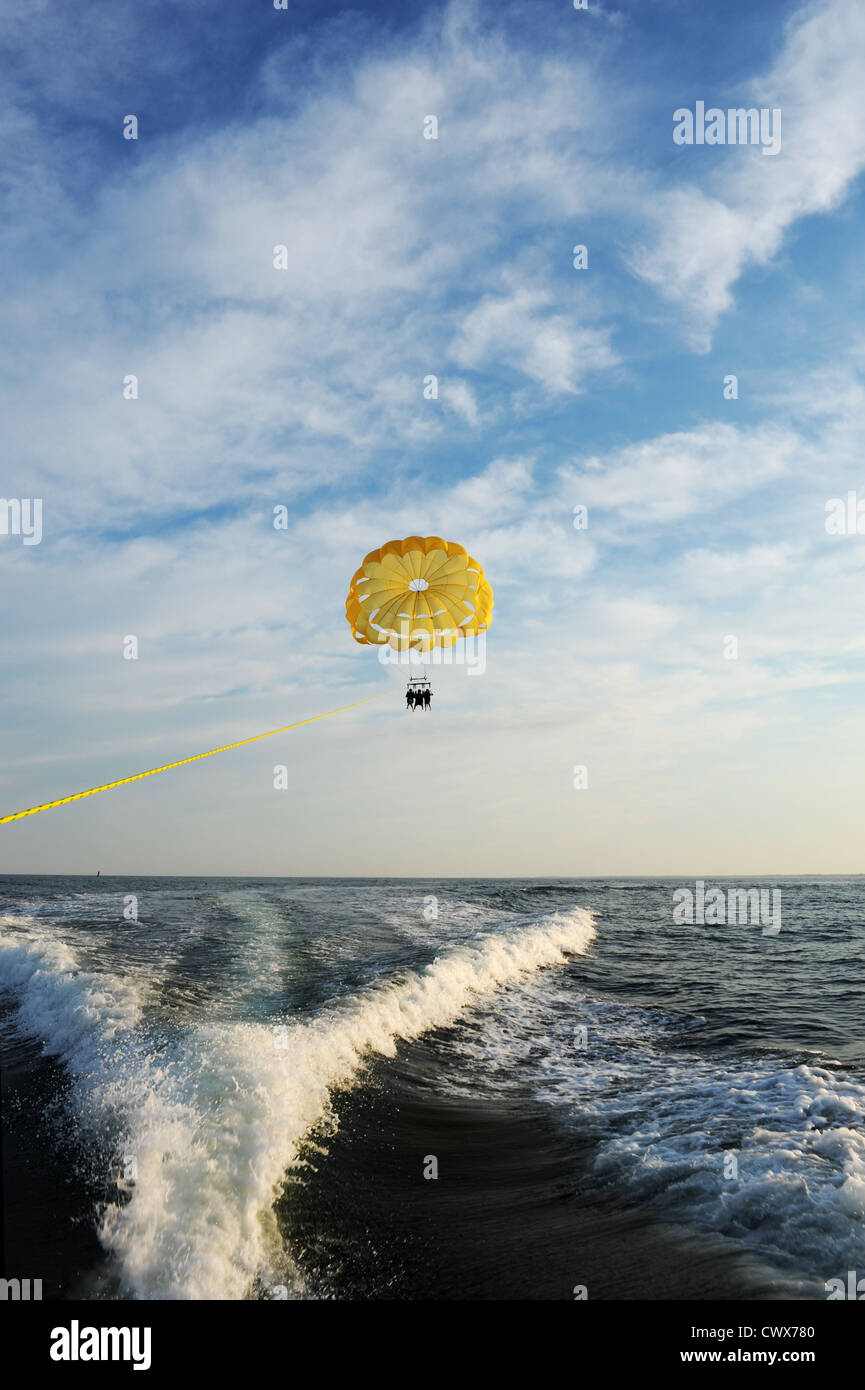 parachute being pulled by a boat in the ocean Stock Photo