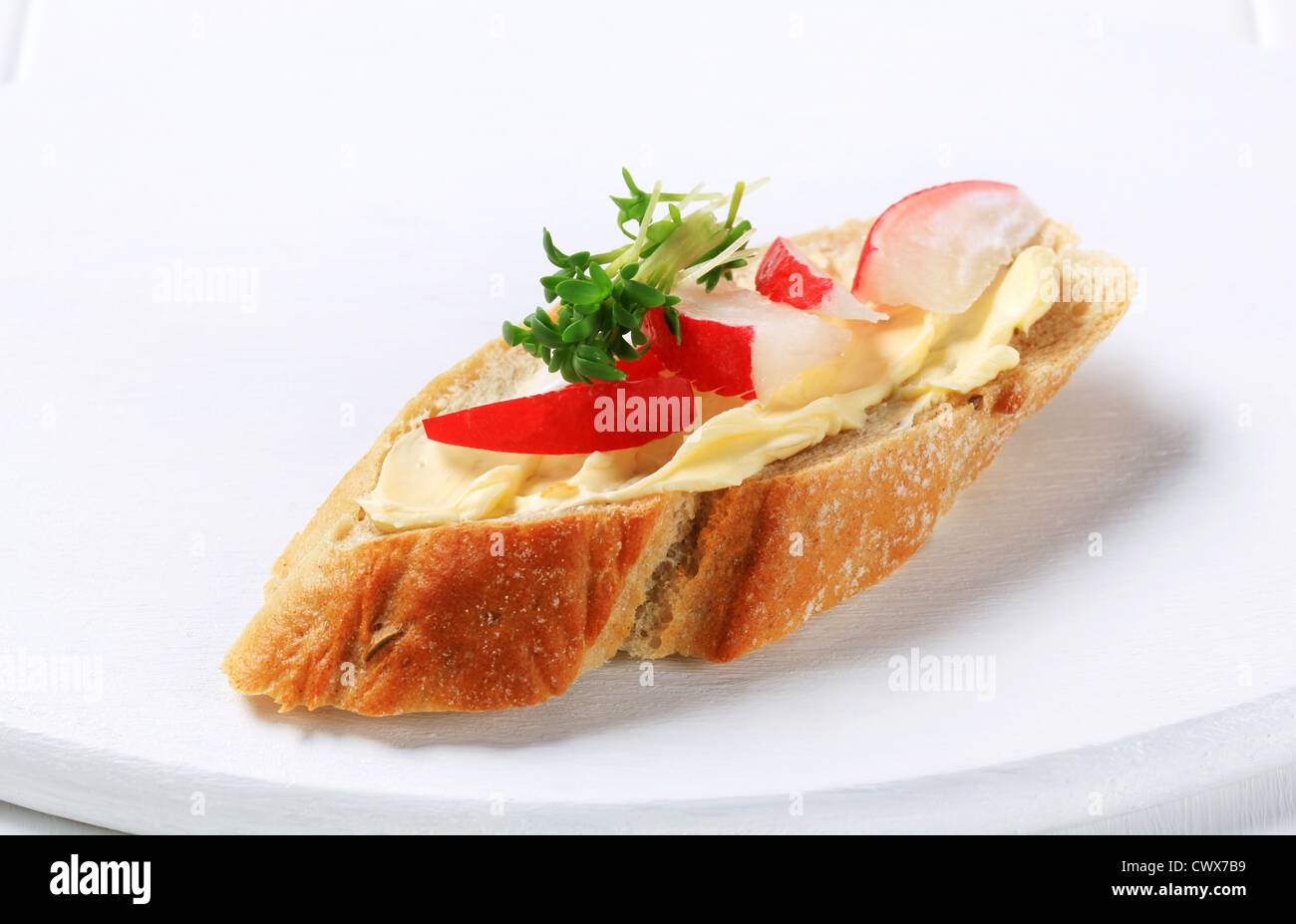 Slice of baguette with butter, radish and cress Stock Photo Alamy