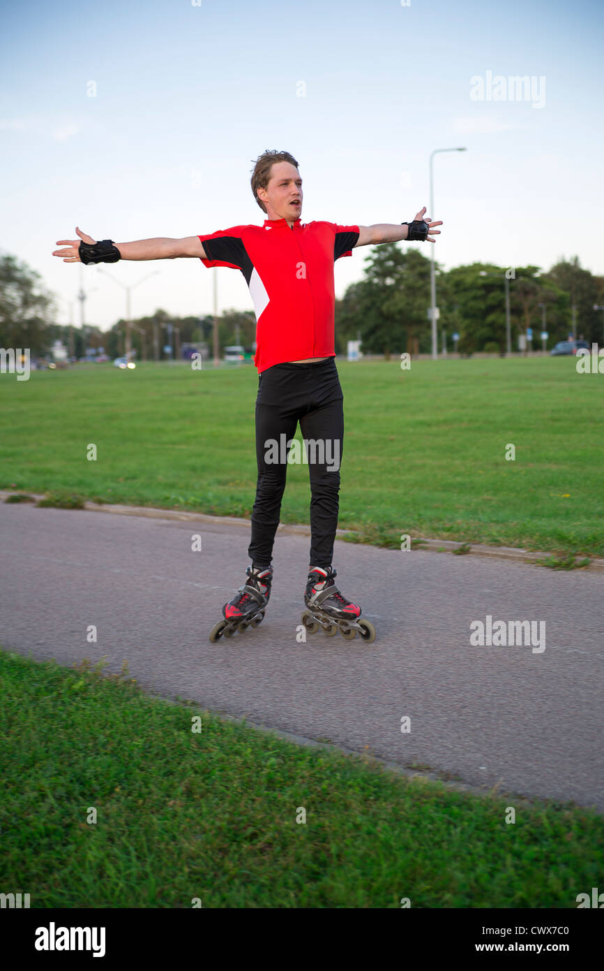 Sportsman on roller skates stand for warming muscles Stock Photo Alamy