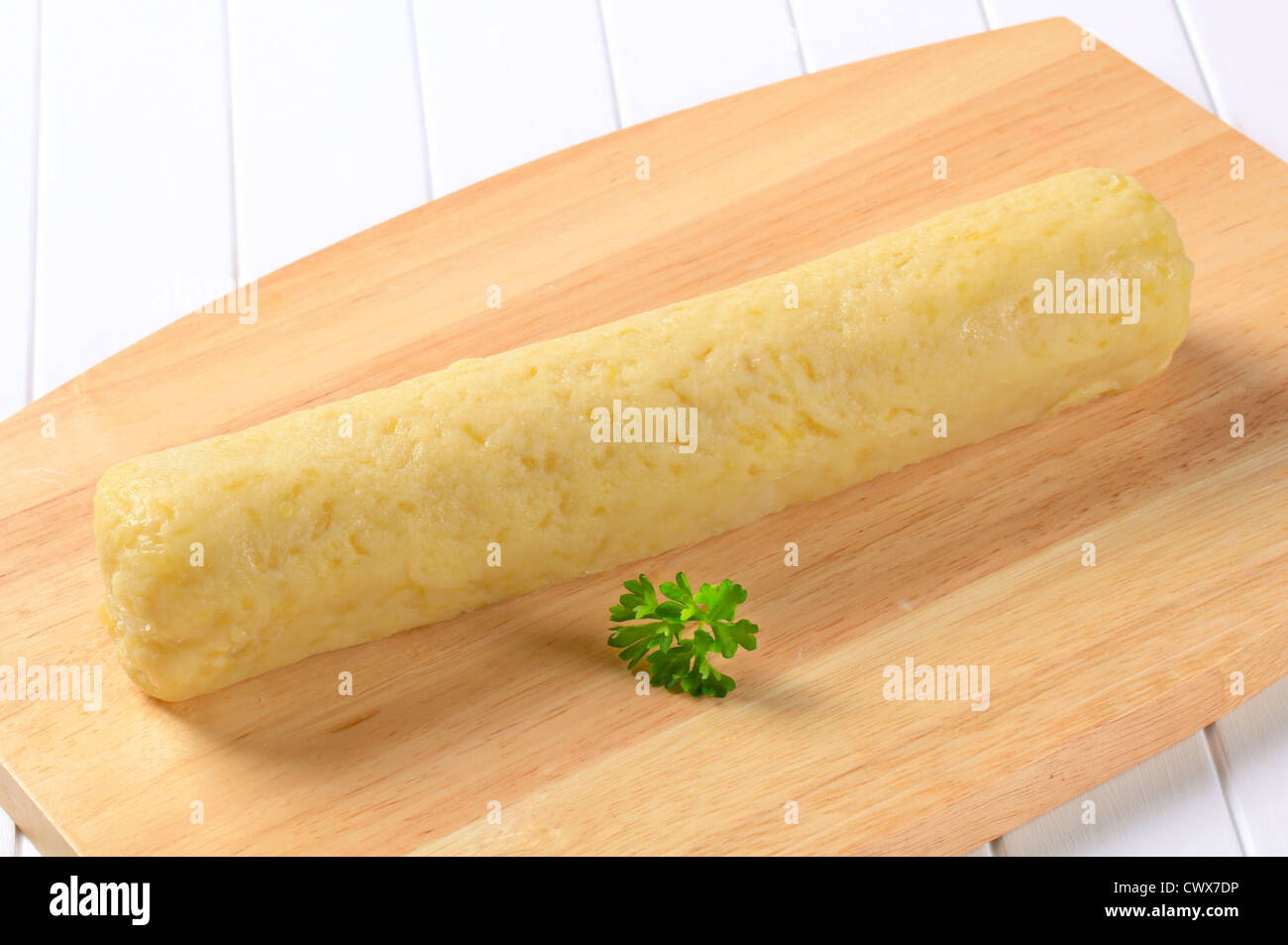 Long roll-shaped potato dumpling ready to be cut into slices Stock Photo