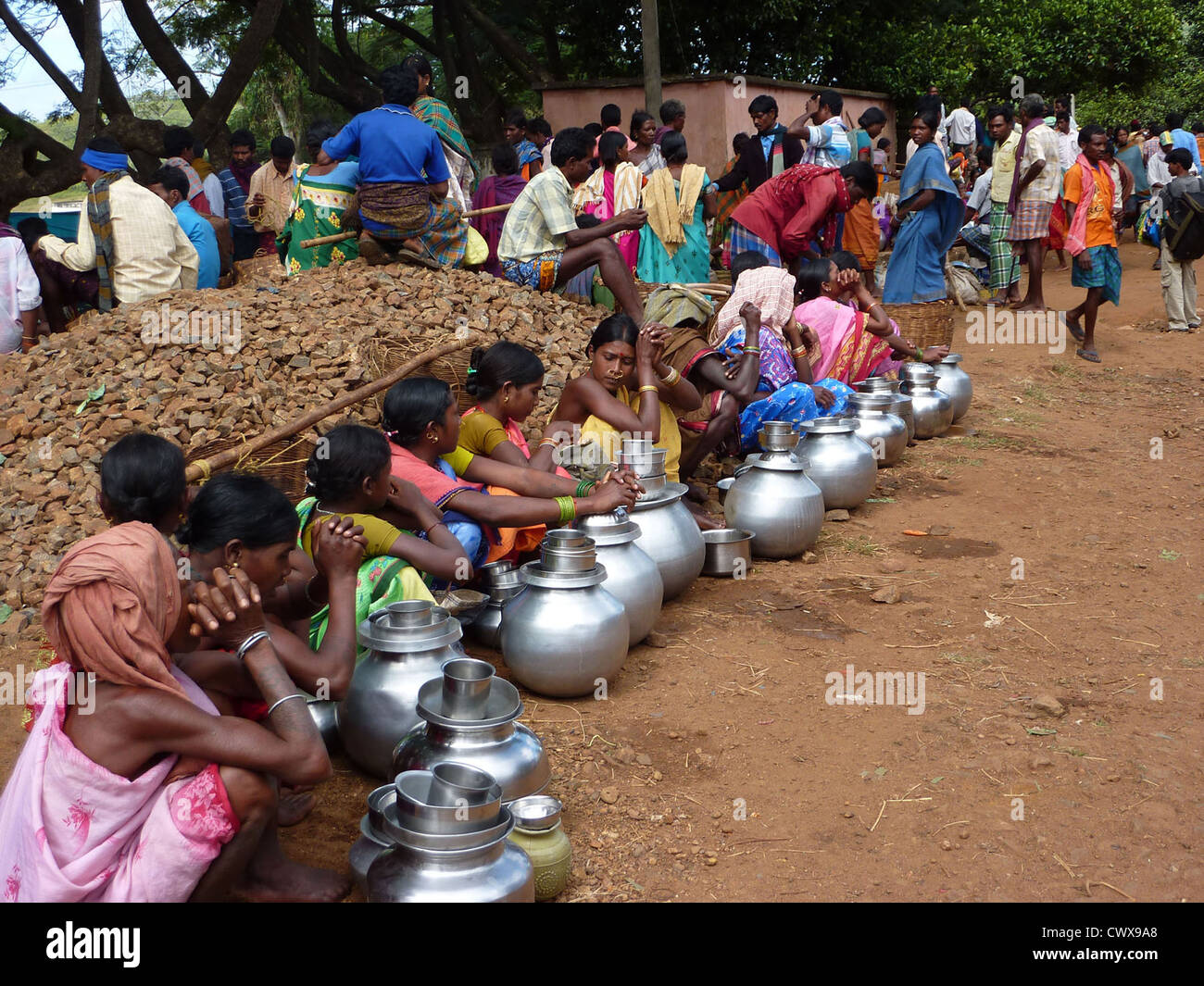 ORISSA, INDIA - Nov 13 - Tribal women sell home brewed liquor from large metal pots on Nov 13, 2009, in Orissa, India Stock Photo