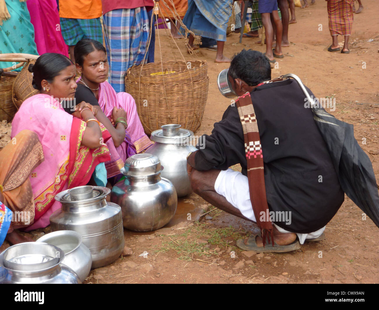 ORISSA, INDIA - Nov 13 - Tribal women sell home brewed liquor from large metal pots on Nov 13, 2009, in Orissa, India Stock Photo