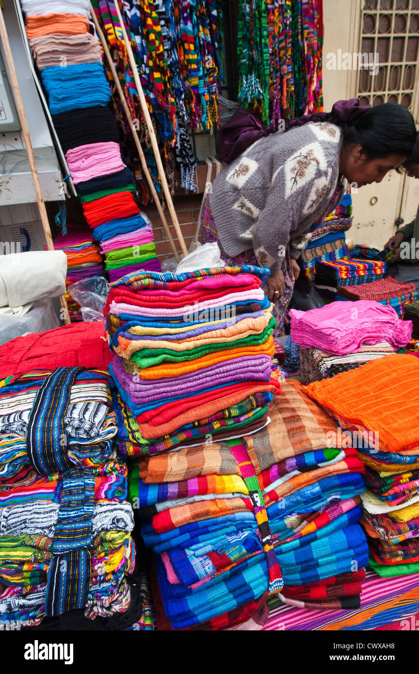 Woven blankets blanket vendor in local market, Chichicastenango, Guatemala. Stock Photo
