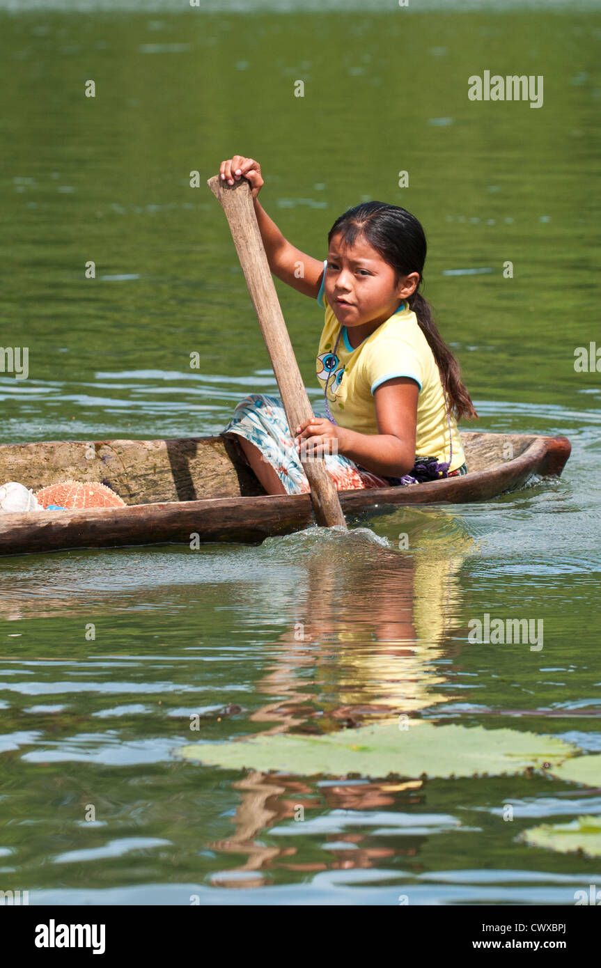 Young indigenous native indian Garifuna girl paddling a 