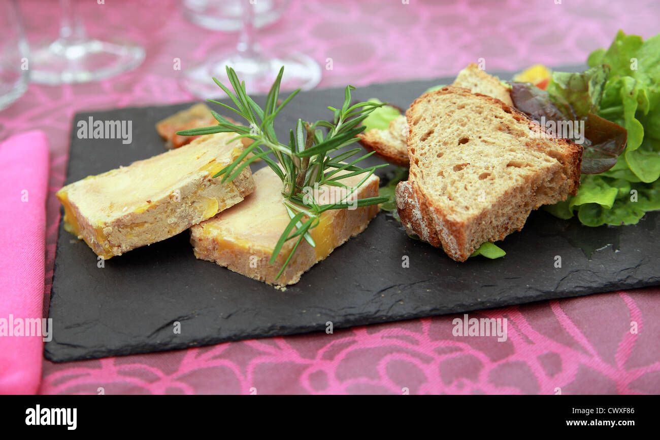 Foie Gras 'Contry Style' : two generous slices of foie gras with country bread served on slate Stock Photo