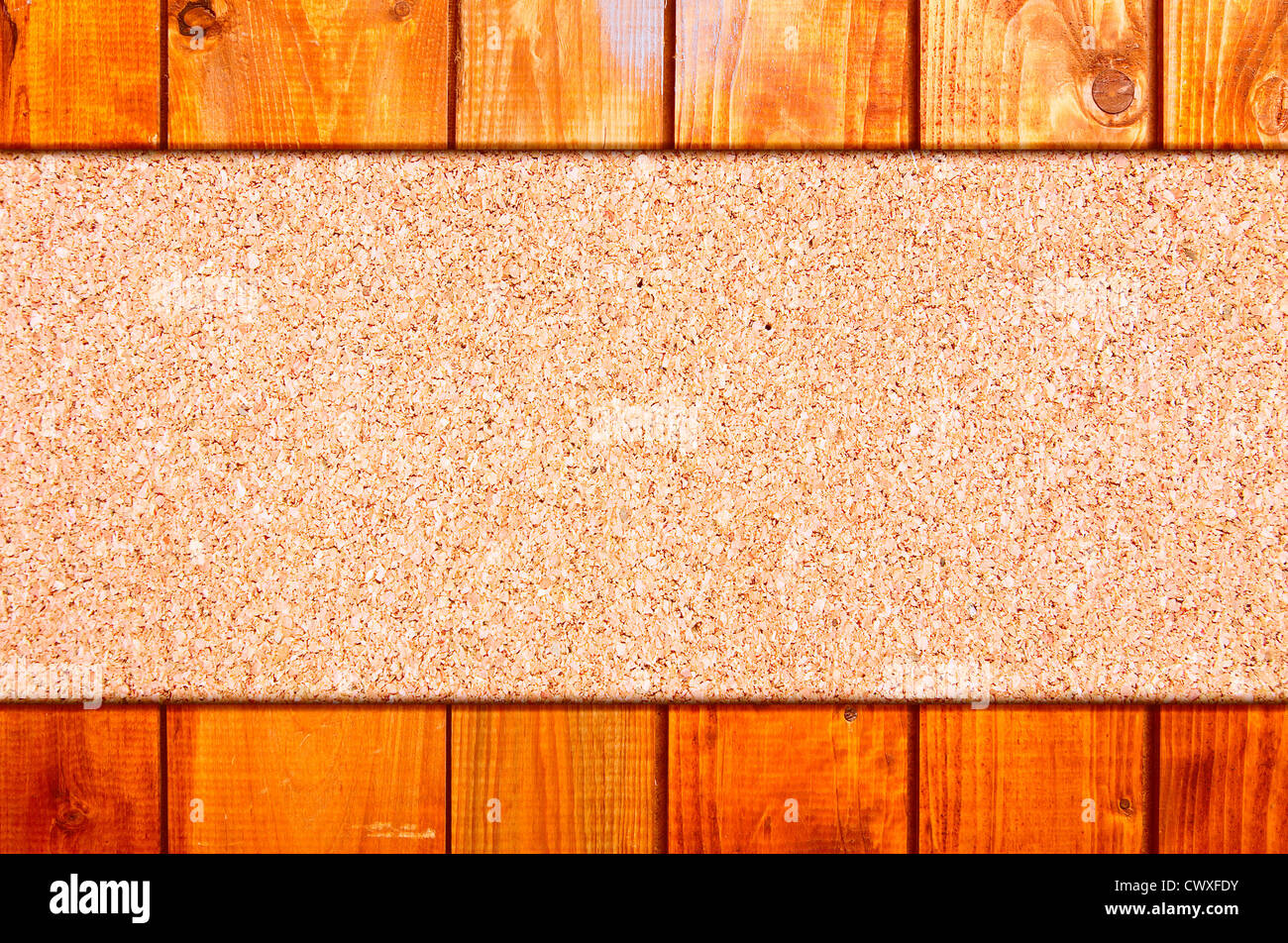 Cork board at wooden panel wall interior background Stock Photo