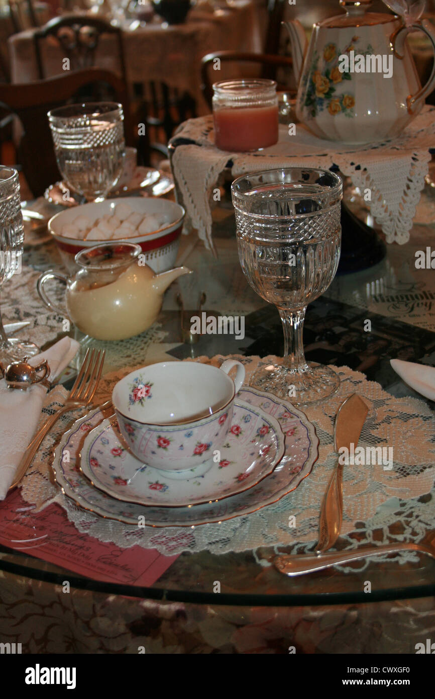 antique dinner setting porcelain china  lace crystal dinnerware and silverware Stock Photo