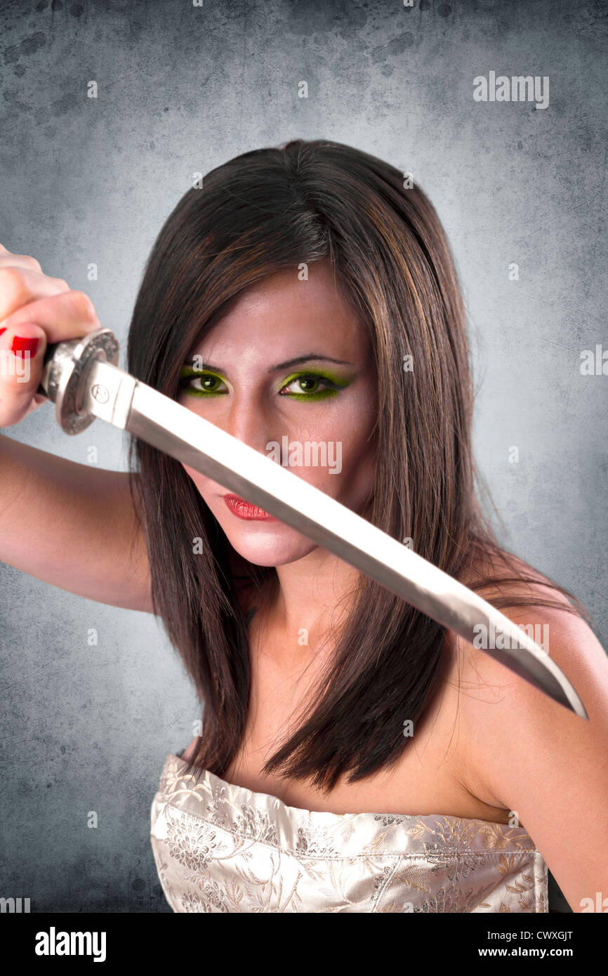 beautiful female warrior holding katana sword ready for the attack Stock Photo