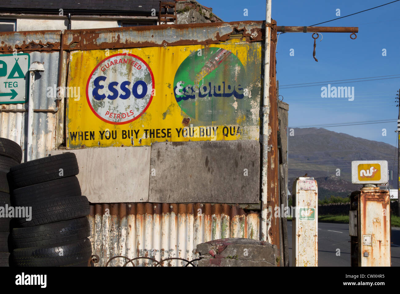 Disused rusty garage and fuel pumps at Llanrug, Snowdonia National Park. Stock Photo