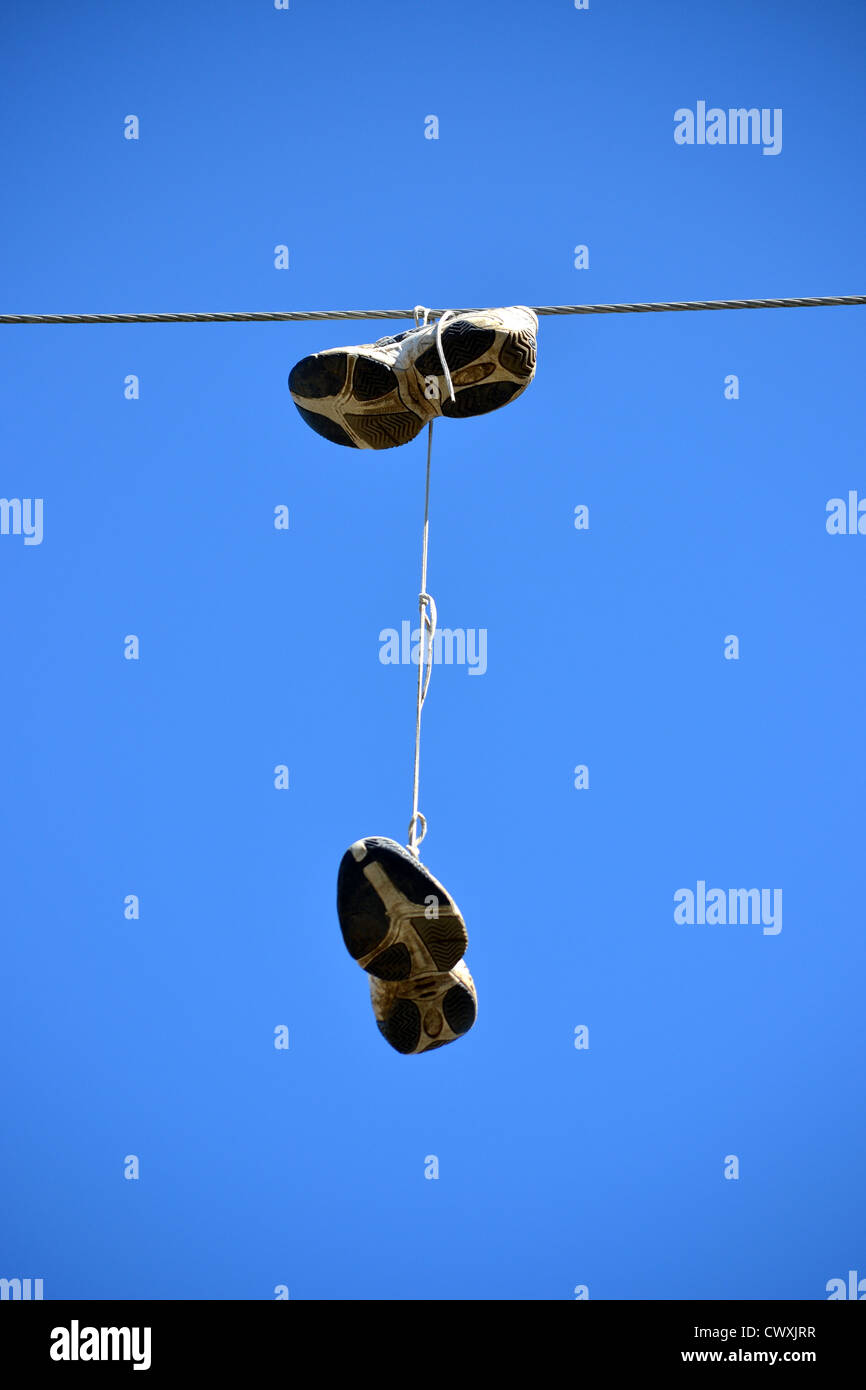 Shoes hanging from power line Stock Photo Alamy