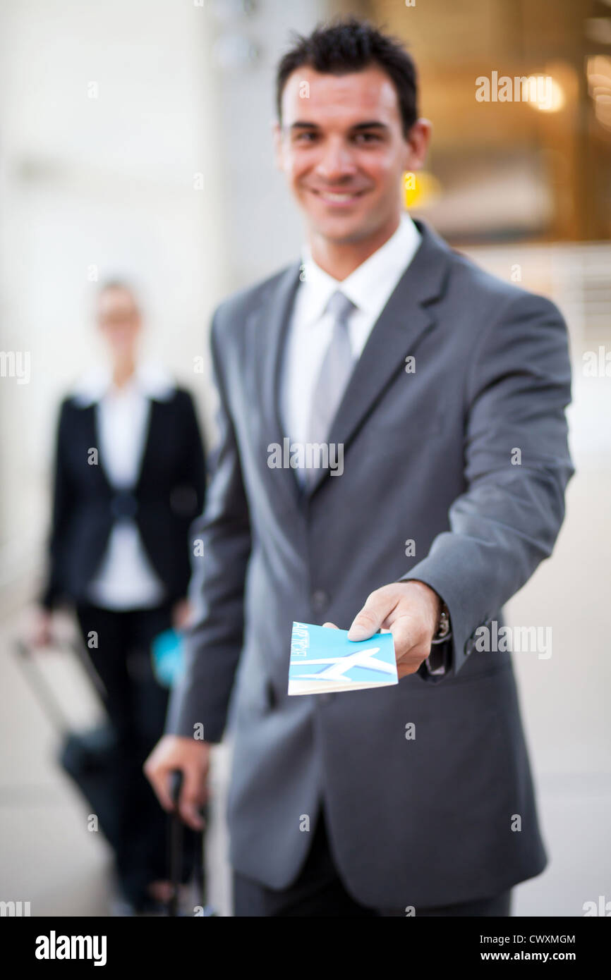 young businessman handing over air ticket, focus on ticket Stock Photo