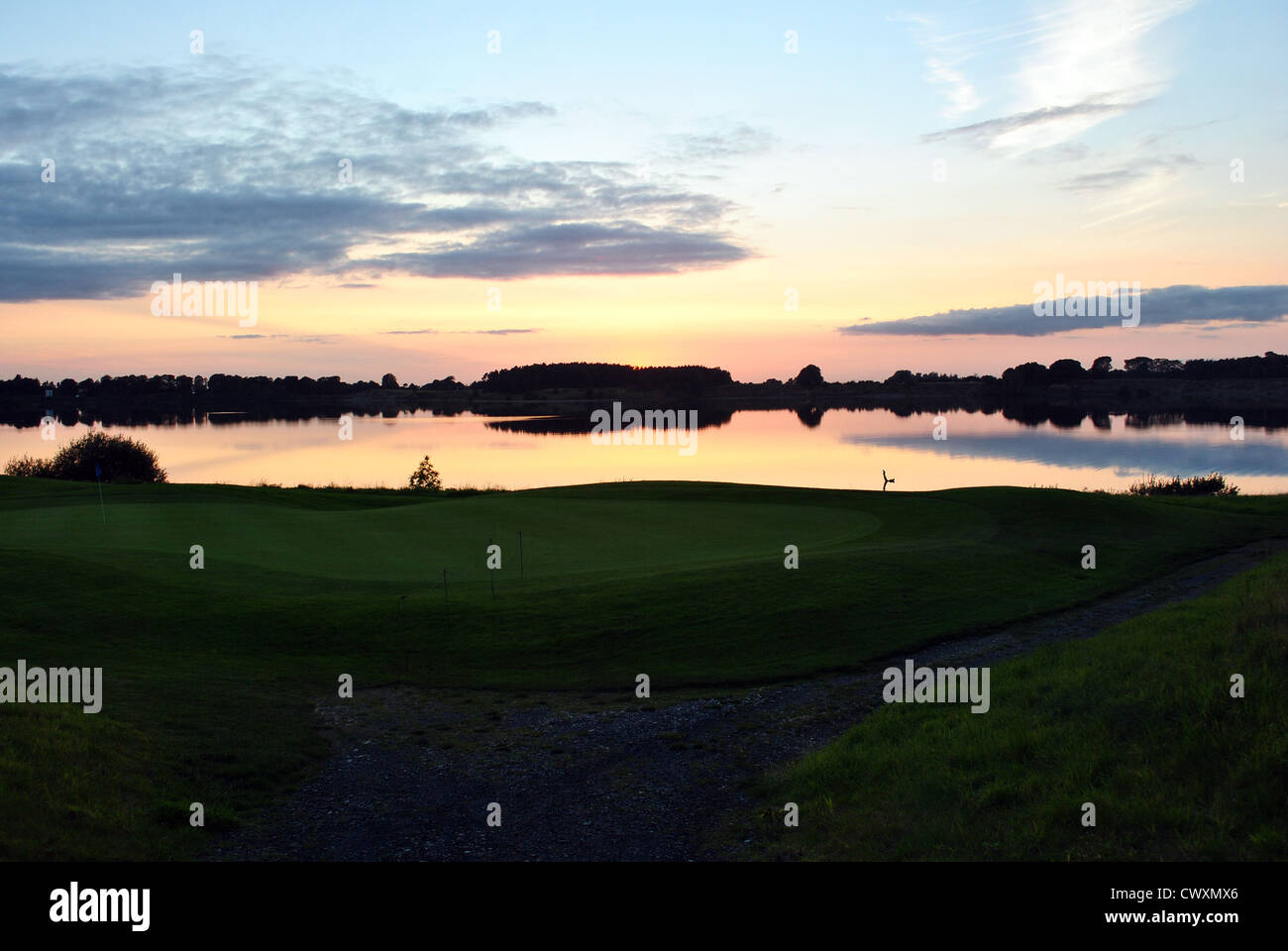 sunset over a lake on a golf course in wicklow ireland Stock Photo