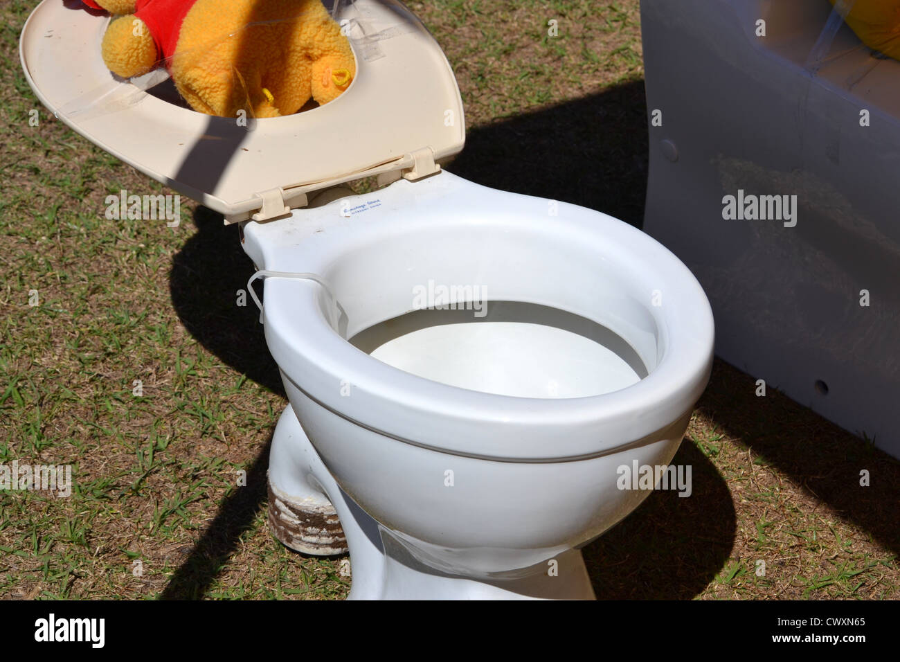 A homemade sideshow alley game at a school fete / fair. Throw a ball into  the toilet and win a prize Stock Photo - Alamy