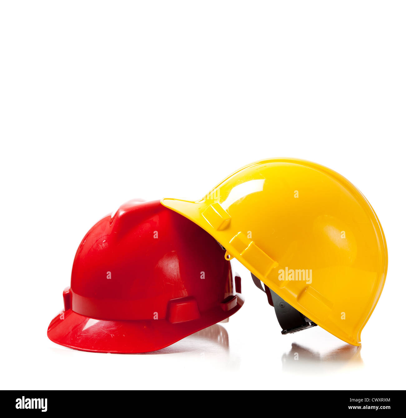 Orange and yellow hardhat on a white background with copy space Stock Photo