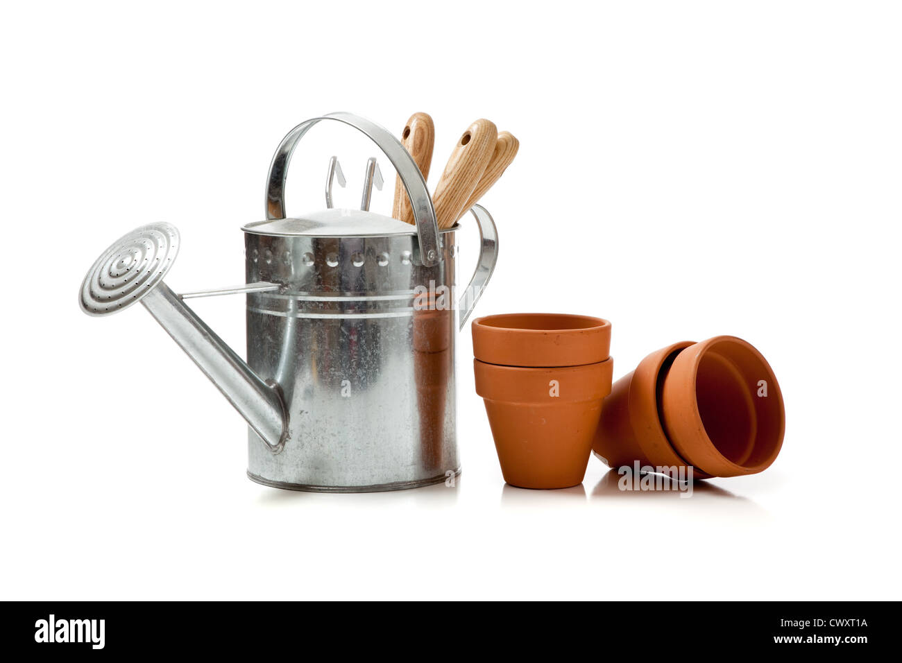 Gardening supplies including terracotta pots, watering can and tools on