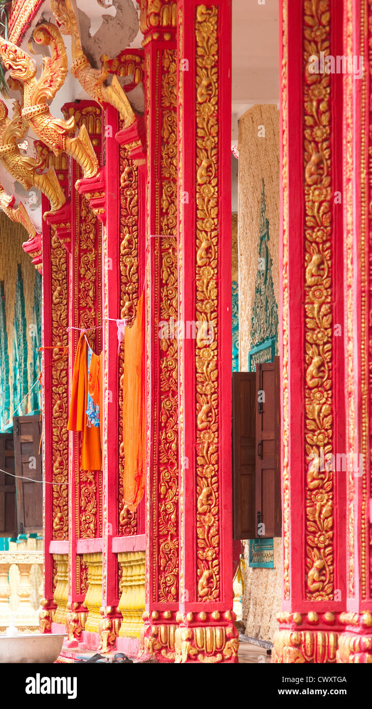 Columns of Buddhist temple in Kampong Speu, Cambodia. Monk robes hanging to dry between the columns. Stock Photo