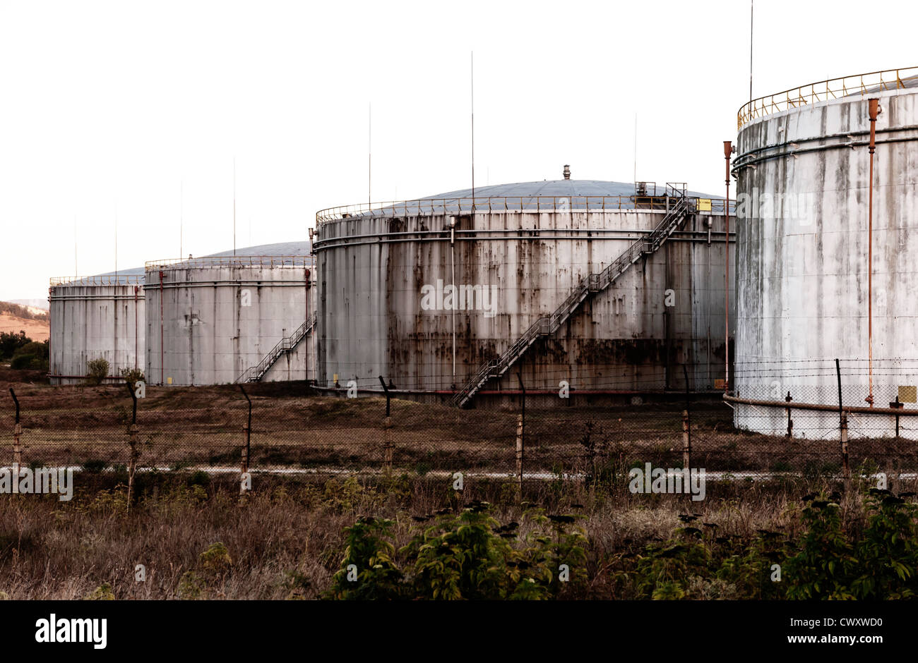 Huge old rusty fuel tanks Stock Photo Alamy