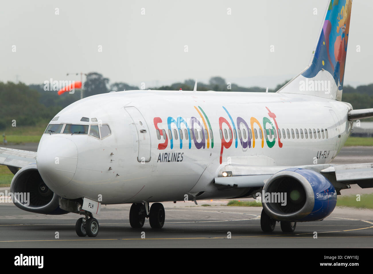 A Lithuanian Small Planet Airlines Boeing 737 taxiing on the runway of Manchester International Airport (Editorial use only) Stock Photo