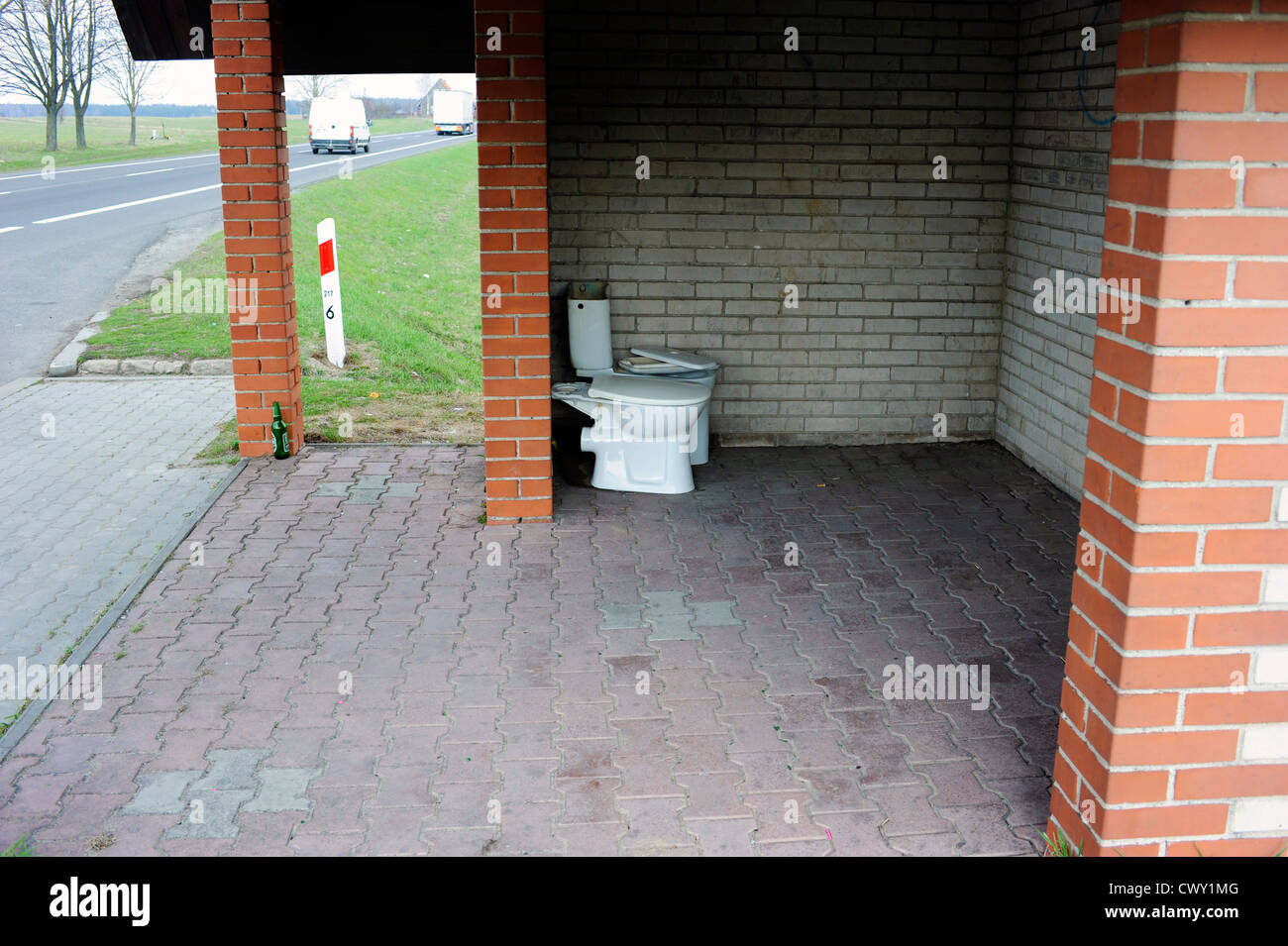 Old toilet bowl placed in a bus stop shelter in north-eastern Poland. Stock Photo