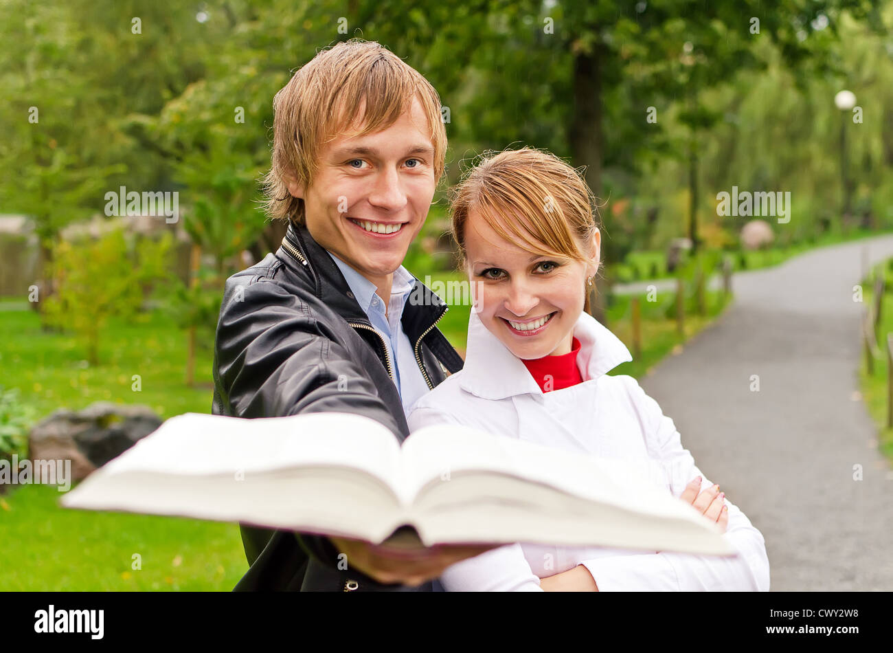 Two students studying outdoors Stock Photo - Alamy