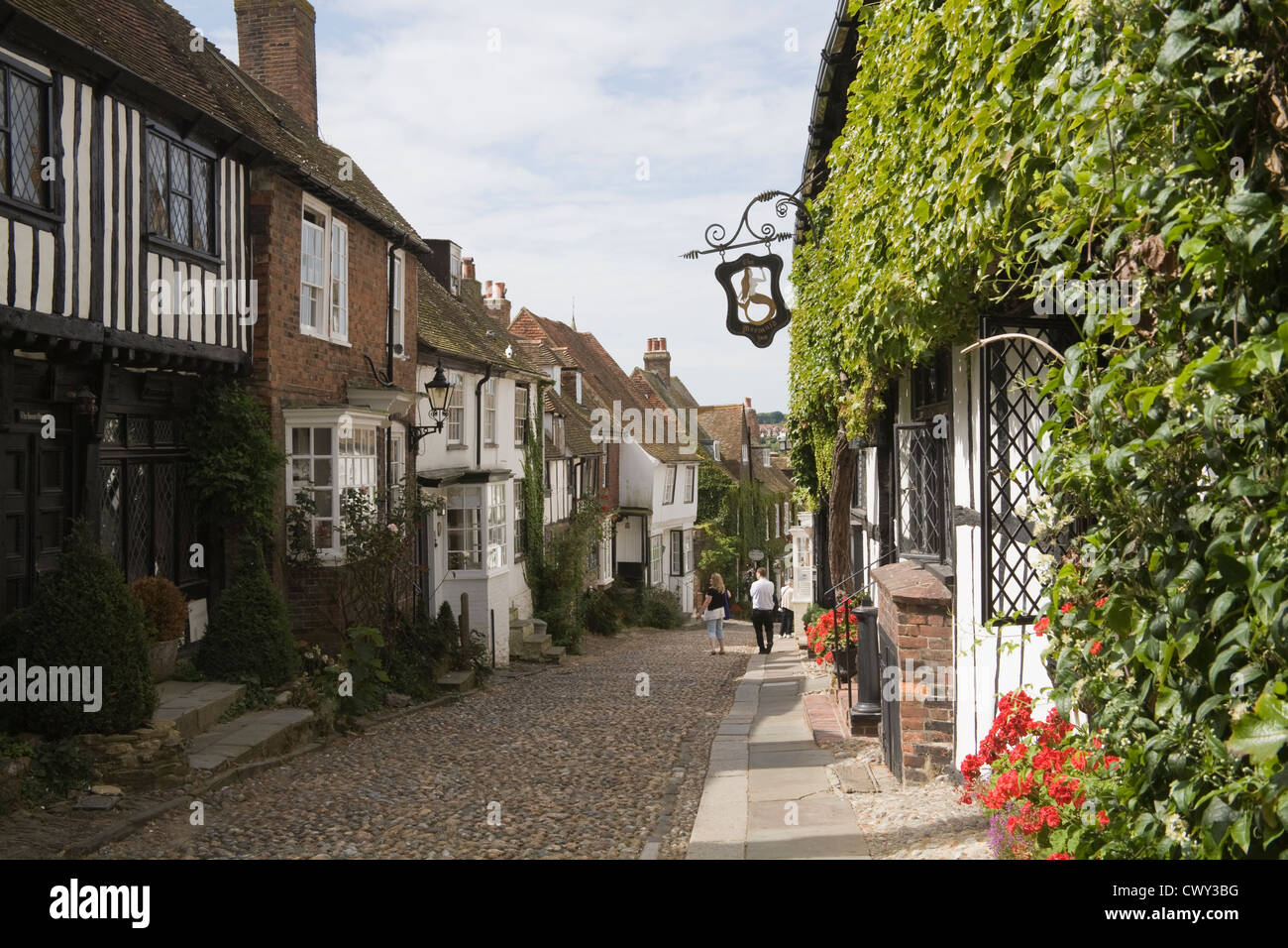 Rye East Sussex England UK Visitors admiring period buildings in medieval cobbled Mermaid Street dating to 16thc Stock Photo