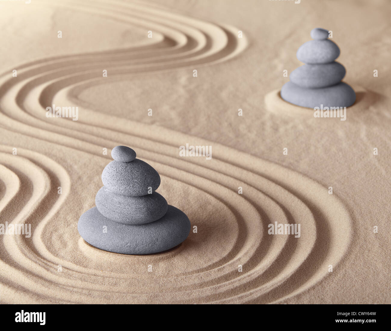 Japanese garden zen meditation stones in balance with pattern in sand concept for harmony and symplicity for relaxation Stock Photo
