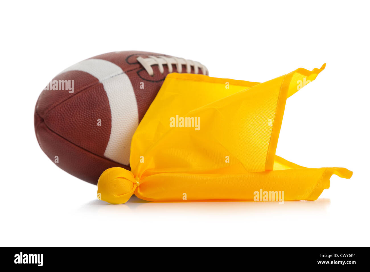 An American football and yellow penalty flag on a white background Stock Photo
