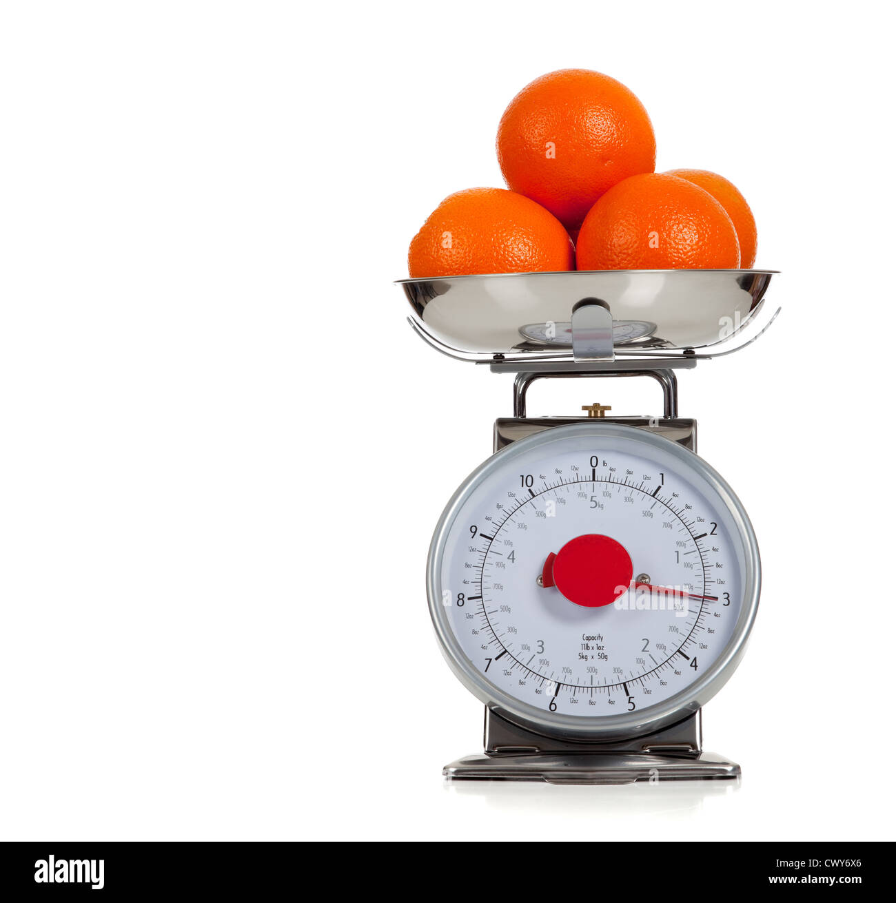 Oranges on a scale with a white background and copy space Stock Photo ...
