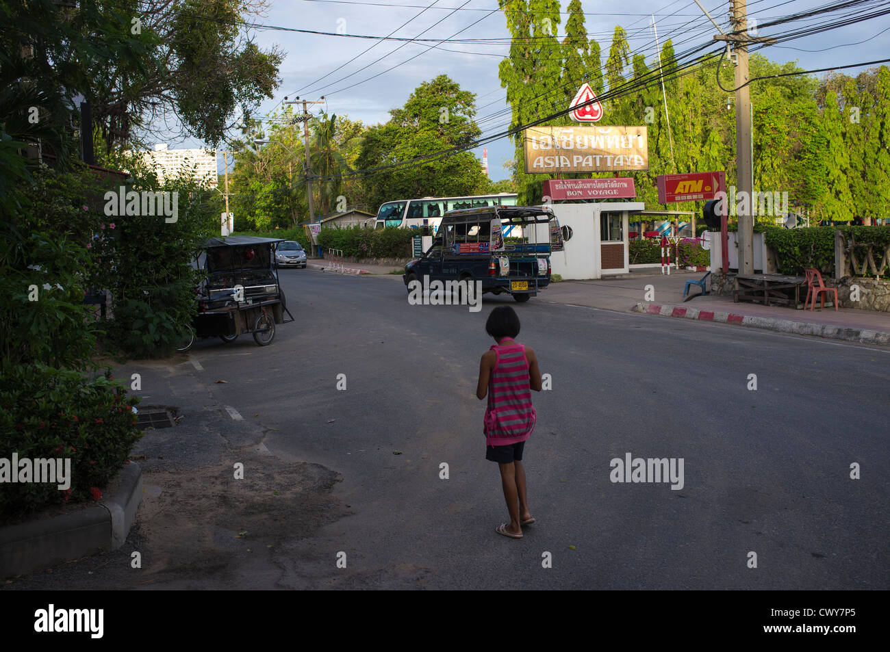 A young girl stands in a street in Pattaya, Thailand Stock Photo